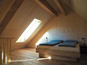 a bedroom with a bed in a attic at Sigmundenhof Schonach in Ölberg