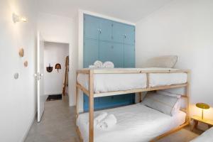 a bedroom with two bunk beds and a blue cabinet at Balaia 9 in Olhos de Água +23 photos