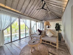 a living room with a couch and a table at BoBos Villa Echo in Canggu +222 photos