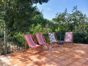 a group of three chairs sitting on a patio at Casa de Andrães - Glicíneas in Marco de Canaveses