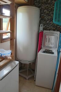 a refrigerator and a stove in a kitchen at Chalet du Lièvre in Hannappes