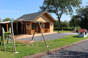 a playground in front of a small house at Chalet du Lièvre in Hannappes