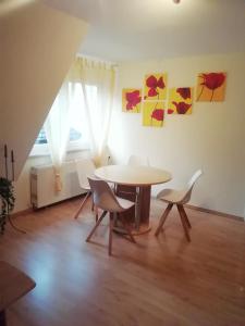 a dining room with a table and chairs and a window at Ferienwohnung Loewe in Plau am See