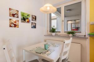 a white table and chairs in a kitchen with a window at Kocher und Jagst in Michelbach an der Bilz +37 photos