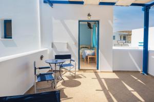 a room with a table and chairs and a door at Studios Ninemia Serifos 5 in Livadi