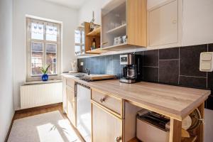 a kitchen with a wooden counter top in a room at Ferienzimmer auf Der Insel Rügen in Sagard