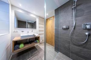 a bathroom with a sink and a shower at Haus Sabrina Rotpleiskopf in See +10 photos