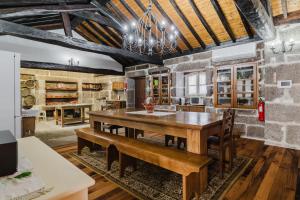 a large dining room with a wooden table and chairs at Cantinho da Tilde in Fafe
