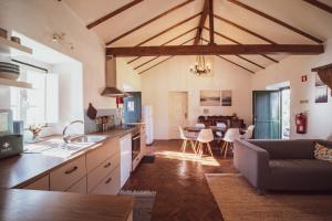 a kitchen and living room with a couch and a table at Vale do Espinheiro in Espinheiro +16 photos