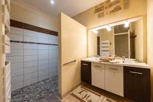 a bathroom with a sink and a mirror at Appartement Andraut - Bazas in Bazas +19 photos