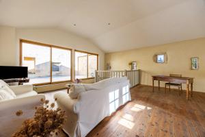 a living room with a white couch and a table at Appartement Andraut - Bazas in Bazas