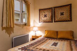 a bedroom with a bed and a window at Appartement Andraut - Bazas in Bazas