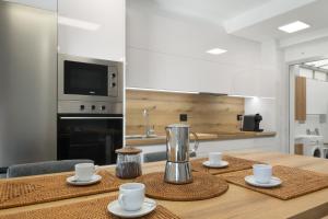 a kitchen with a wooden table with a blender on it at S Q Playa de Sardina in Gáldar