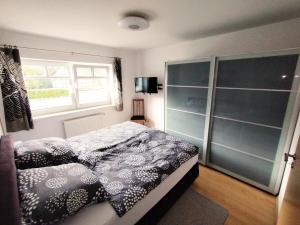 a bedroom with a bed and a window at Ferienwohnung Am Kamp in Schmallenberg