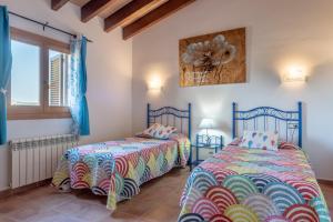 two beds sitting next to each other in a room at Solluna in Son Servera +19 photos