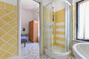 a bathroom with a shower and a tub at Casa La Torre in Capoliveri