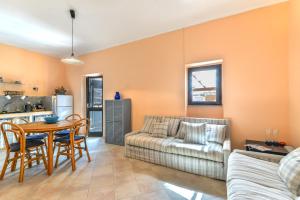 a living room with a couch and a table at Casa La Torre in Capoliveri +20 photos