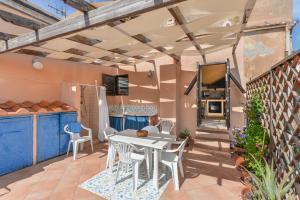 a patio with a white table and chairs at Casa La Torre in Capoliveri