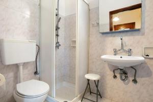 a bathroom with a toilet and a sink at Areti Orfeas Apartment 6 in Vasilikos