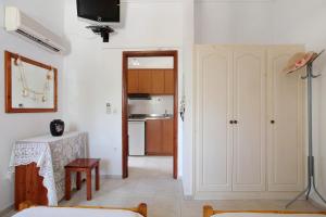a living room with a table and a kitchen at Areti Orfeas Apartment 6 in Vasilikos +15 photos