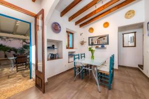 a dining room with a table and chairs at Finca Es Carregador in Capdepera