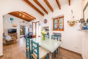 a kitchen and dining room with a table and chairs at Finca Es Carregador in Capdepera