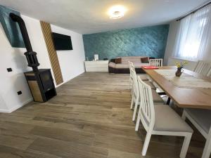 a living room with a dining table and a fireplace at Cabana Patric Valea Avrigului in Avrig