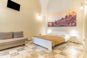 a bedroom with a bed and a couch at Sg Apartment Standard Plus in Massafra