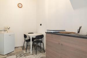 a kitchen with a small table and two chairs at Sg Apartment Standard Plus in Massafra