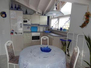 a kitchen with a table with a blue bowl on it at Fewo Singler in Hofstetten