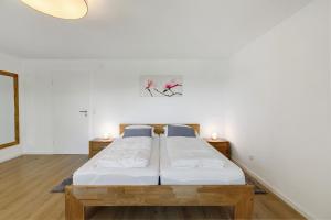 a bedroom with a bed and two night stands at Ferienwohnung Staffe in Bonndorf im Schwarzwald