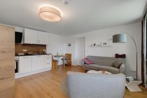 a living room with a couch and a kitchen at Ferienwohnung Staffe in Bonndorf im Schwarzwald
