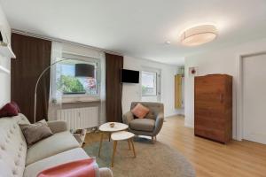 a living room with a couch and a chair at Ferienwohnung Staffe in Bonndorf im Schwarzwald