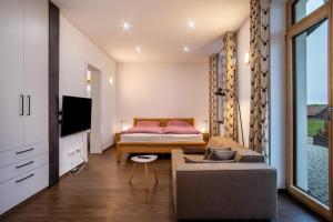 a living room with a couch and a bed at Butterei in Argenbühl