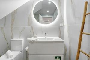 a white bathroom with a sink and a mirror at Studio Casa Belavista in Gaula +15 photos