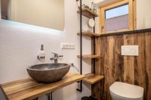 a bathroom with a sink and a toilet at Butterei in Argenbühl +19 photos