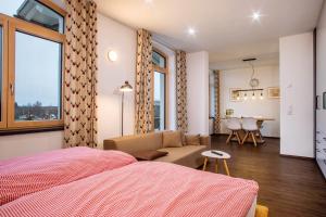 a bedroom with a bed and a living room at Butterei in Argenbühl