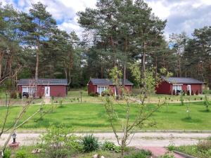 two red houses in a field with trees at Ferienhaus Weitblick in Zossen
