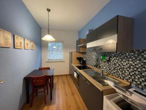 a kitchen with a sink and a table in it at Ferienhaus Weitblick in Zossen