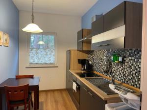 a kitchen with a sink and a counter top at Ferienhaus Weitblick in Zossen +30 photos
