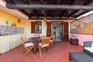 a kitchen and dining room with a table and chairs at Attico il Mandorleto in Villasimius