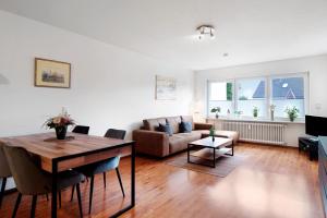a living room with a table and a couch at Agricola in Bad Säckingen