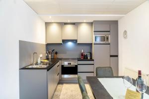 a kitchen with stainless steel appliances and a table at Wohlfühlnest in Nauders