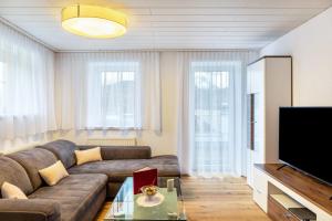 a living room with a couch and a flat screen tv at Wohlfühlnest in Nauders