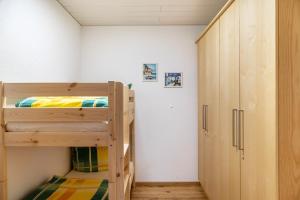 a bedroom with two bunk beds and a closet at Wohlfühlnest in Nauders