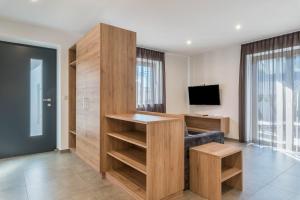 a living room with a desk and a tv at Aster Moments Apt Max in San Genesio Atesino