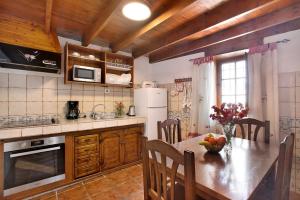 a kitchen with a table and a refrigerator at los diablitos 2b - Ideal familias in San Juan de la Rambla