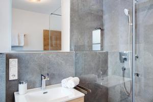 a bathroom with a sink and a shower at Ferienwohnung Alpenveilchen in Grainau +13 photos