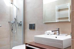 a bathroom with a white sink and a shower at Kriendl Nr 4 in Valdaora +19 photos