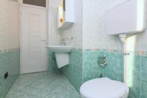 a bathroom with a toilet and a sink at Liver 201 in Tremosine Sul Garda +22 photos